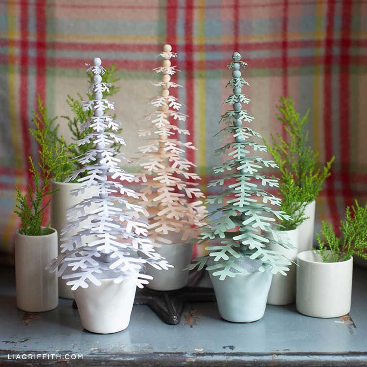 paper holiday trees in pots on mantel